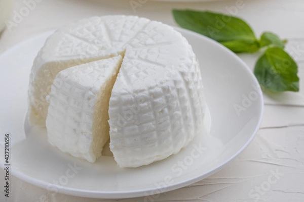 Obraz Round cottage cheese on white background.Close-up