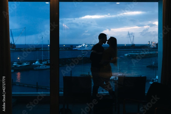 Fototapeta couple on the background of the port hugging and spending time together, travel concept.