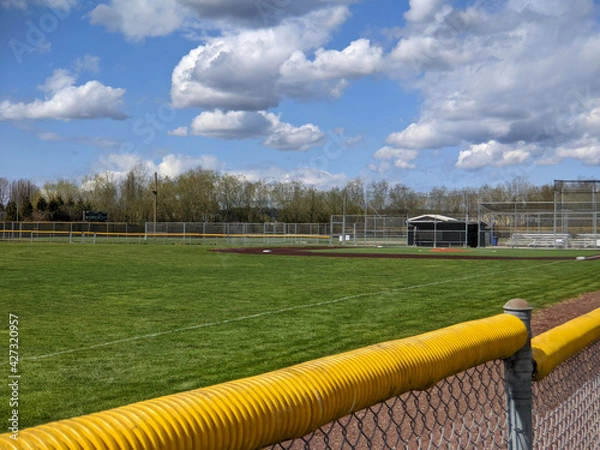 Fototapeta a large, empty baseball field on a bright, sunny day