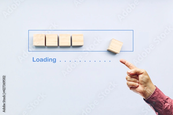 Fototapeta Pointing progress bar filling with wooden cubes. Loading status