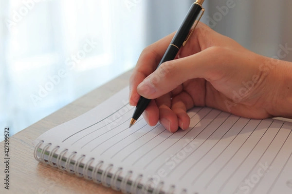 Obraz writing on a notebook