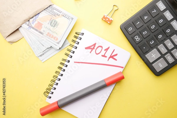 Fototapeta Notepad with word 401k on yellow background, top view 