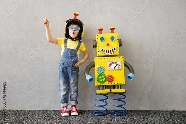 Fototapeta Happy child with toy robot