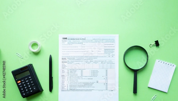 Fototapeta 1040 individual tax form. Pen, calculator, notepad and magnifier. Tax concept. With space for text