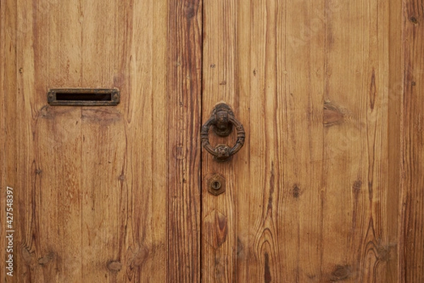 Fototapeta old wooden door with lock and hole to put the letter