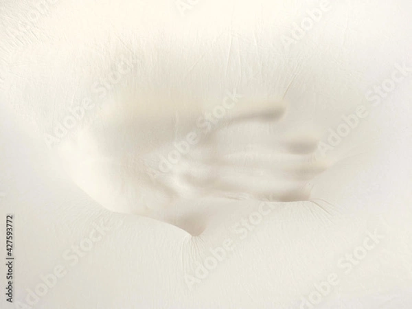 Fototapeta Orthopedic pillow, memory foam. Handprint on the pillow. Comfortable bedding with orthopaedic, therapeutic effect. Memory foam material.