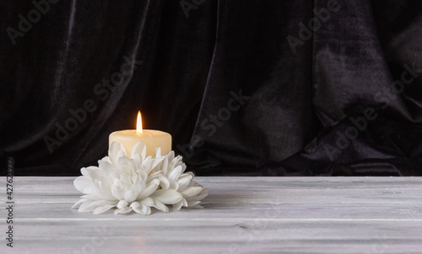 Obraz The concept of remembrance, funerals, and condolences. Candle and white flowers, free space for text