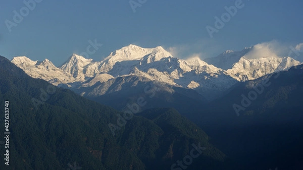 Fototapeta Scenic morning panorama on snow-capped Kangchenjunga mountain in Himalaya range seen from Pelling, Sikkim, India