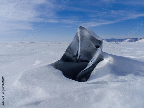 Fototapeta fancifully frozen ice of lake baikal on a sunny day. Siberia Russia