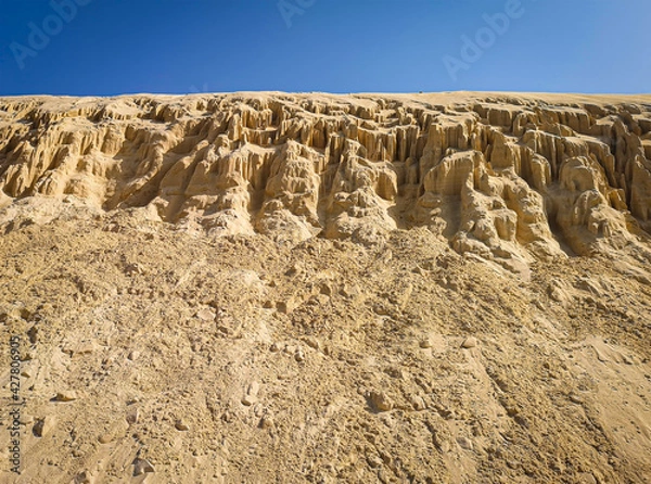 Obraz Formations of sand on the beach in Boa Vista Island, Cape Verde. Erosion of sandstone on the coast of Atlantic Ocean. Selective focus on the texture, blurred background.