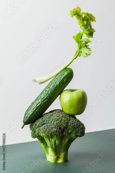 Fototapeta Fresh green vegetables on on the table. Equilibrium floating food balance. Food creative concept, levitation