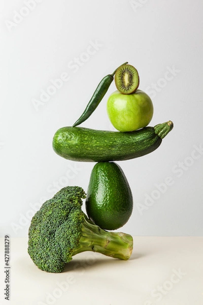 Fototapeta Fresh green vegetables on on the table. Equilibrium floating food balance. Food creative concept, levitation