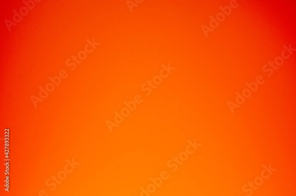 Fototapeta A light to dark orange gradient texture for the background.
