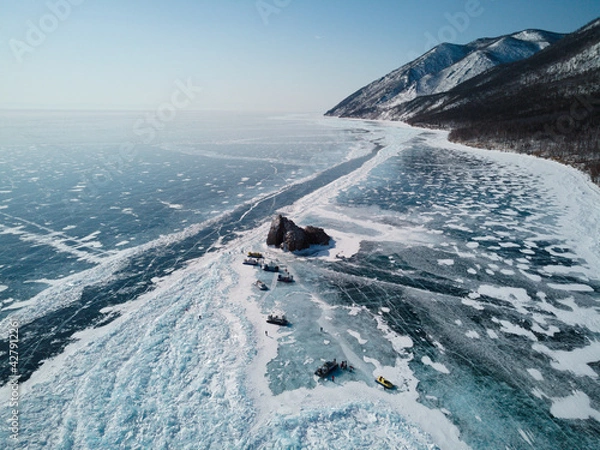 Fototapeta Winter top view of the coastline of Lake Baikal, the bay, the rocks and the surrounding mountains. Siberia. Russia.