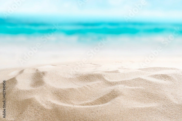 Fototapeta Empty sandy beach. Little shells in the sand. Splashing waves on the seashore. Summer.