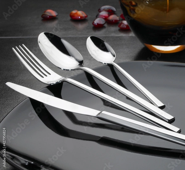 Obraz steel cutlery set on black elegant table 