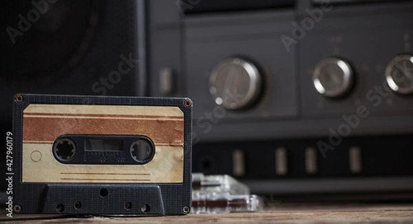 Obraz old tape recorder and cassette on  wooden table