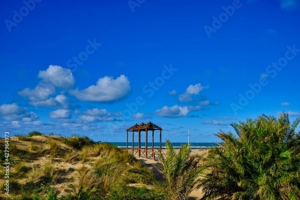 Fototapeta Wooden structure in the dunes at th e beach