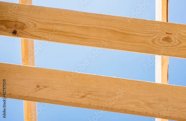 Fototapeta a fragment of a pine board against the sky