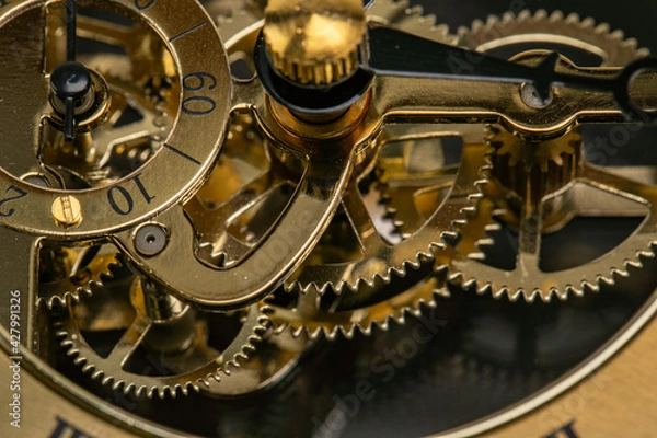 Obraz Close Up of the mechanisms and gears of a gold watch clock face
