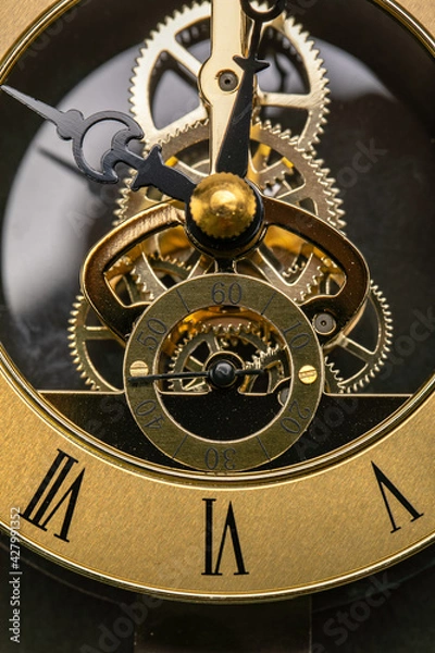 Obraz Close Up of the mechanisms and gears of a gold watch clock face
