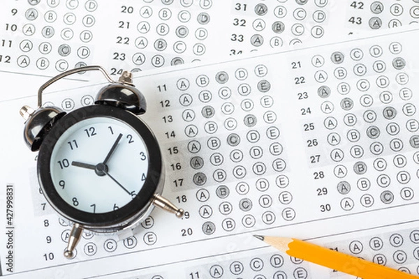 Obraz alarm clock, optical form of standardized school test with bubble and black pencil, answer sheet, education concept