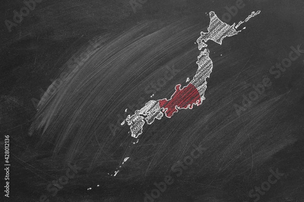 Fototapeta Country map and flag of Japan drawing with chalk on a blackboard. One of a large series of maps and flags of different countries. Education, travel, study abroad concept.