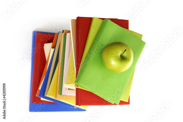Obraz top view of stack of books with green apple