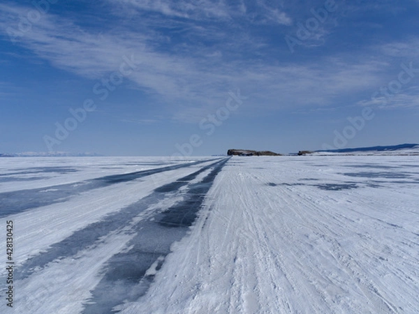 Fototapeta a road going into the distance on the ice of Lake Baikal along the island of Olkhon. Winter Siberia Russia