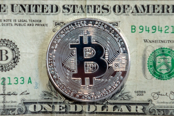 Obraz bitcoin coin on a dollar