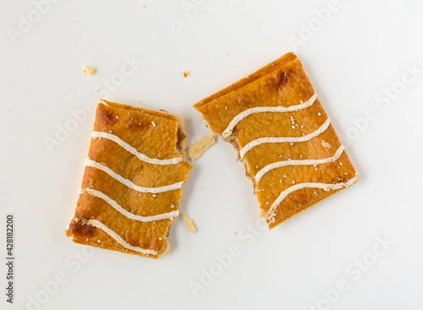 Fototapeta Broken cinnamon sugar toaster pastries with apple filling on a white background.