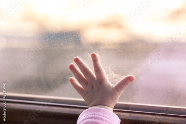 Fototapeta Child's hand leaning against the window. Frost outside the window