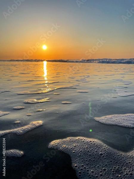 Fototapeta sunset over the sea waves