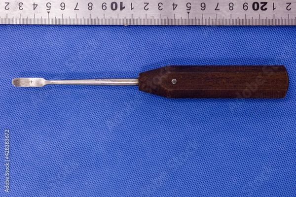 Fototapeta Periosteal elevator on a blue background