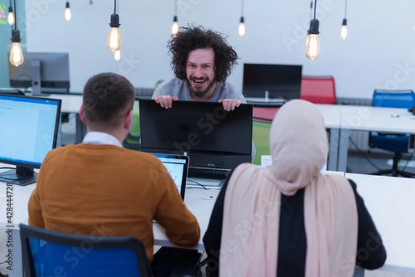Fototapeta Creative multiethnic business people group as freelancers in modern coworking open space office working together