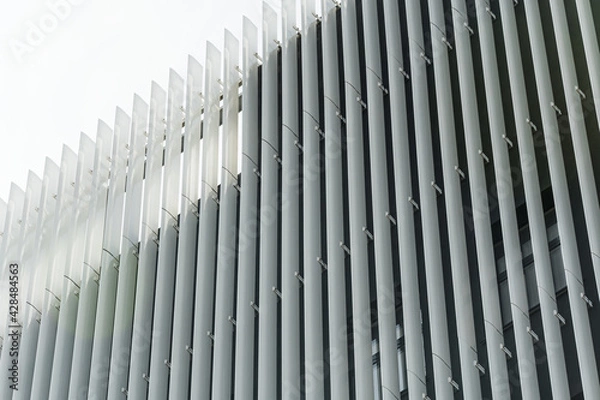 Obraz Geometric colored building facade elements with planes, lines and corners with light flare and reflections for an abstract background and texture of white, blue, gray colors. Place for text