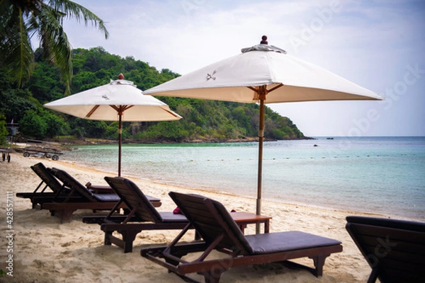 Obraz Beach chair under coconut tree looking away to sea view. Praw Bay, Samed,Thailand.