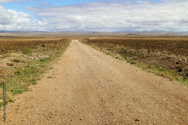 Fototapeta Dirt road in the stone desert between Midelt and Gorges du Ziz in the Middle Atlas region in Morocco, Africa
