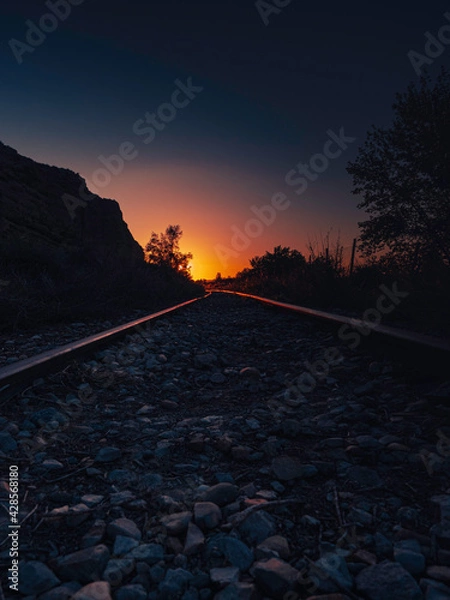 Fototapeta Dawn over a railway track. The golden hour.
