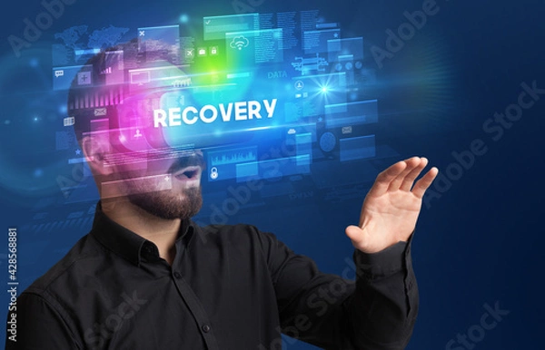 Fototapeta Businessman looking through Virtual Reality glasses