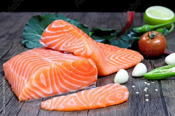 Obraz Fresh salmon with spices  on the table, garlic, tomato and lemon