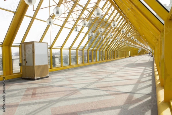 Fototapeta Pedestrian bridge in Gorky Park (St. Andrew's Bridge) with yellow steel structures, view from the inside