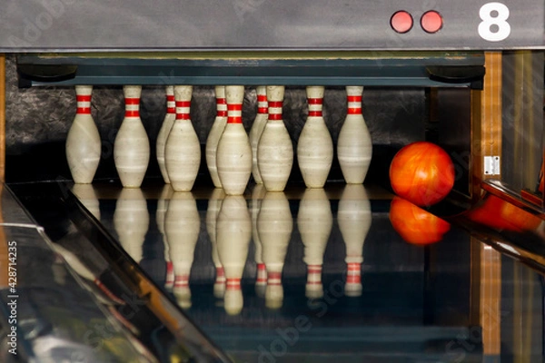 Fototapeta The fall of the ball into the gutter close to the pins. Unsuccessful throw. Lack of precision in the game.