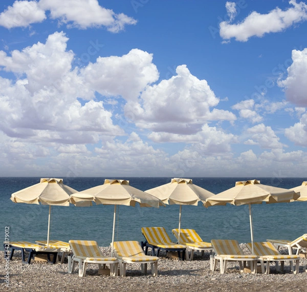 Fototapeta sun umbrella and chairs on a beach