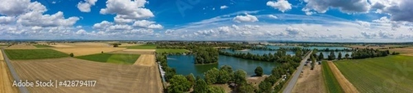 Fototapeta View from the bird's eye view of the quarry ponds in the Hessian Ried / Germany in wonderful sunshine 