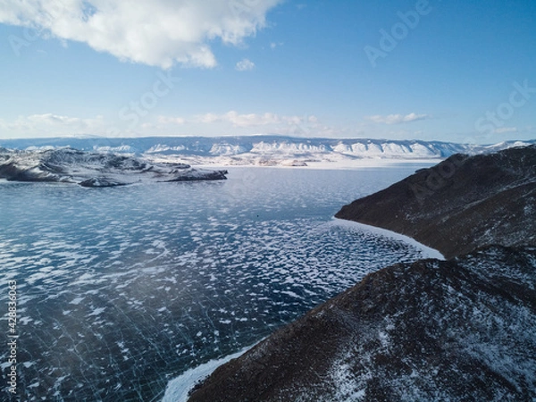 Fototapeta view from the drone on the hilly coast of the island of Olkhon and the frozen Lake Baikal. Siberia Russia