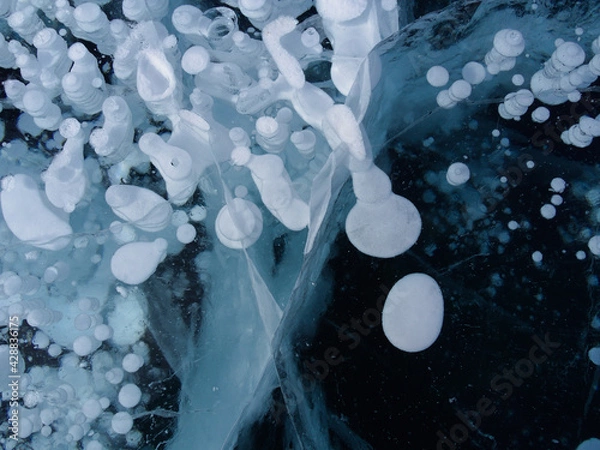 Fototapeta unusual frozen gas bubbles in the crystal clear ice of Lake Baikal. Siberia Russia