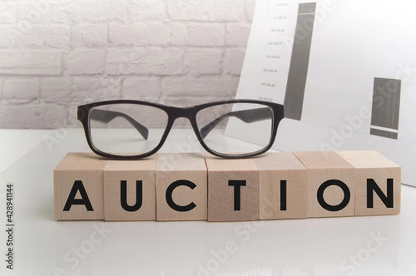 Obraz Action word on wooden cubes on white office background with glasses, documents and brick wall