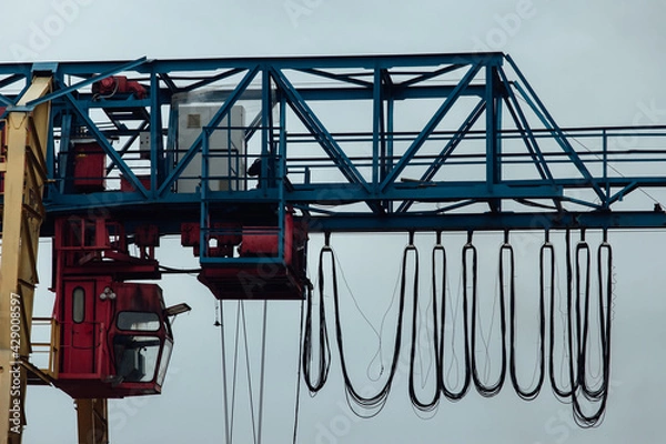 Fototapeta the cabin of a gantry crane for transporting goods in the factory. automated control of the weight loader