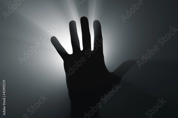 Fototapeta Raised hand in the spotlight.